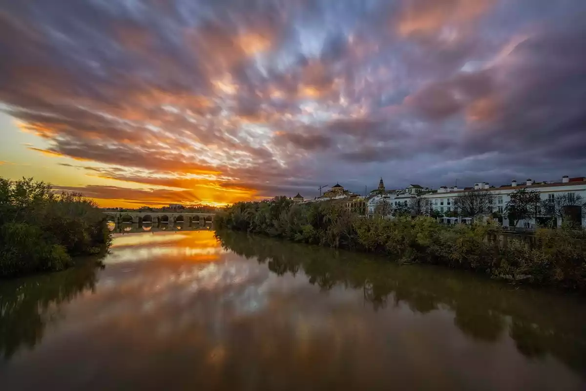 Imagen de una salida de sol entre nubes en Córdoba