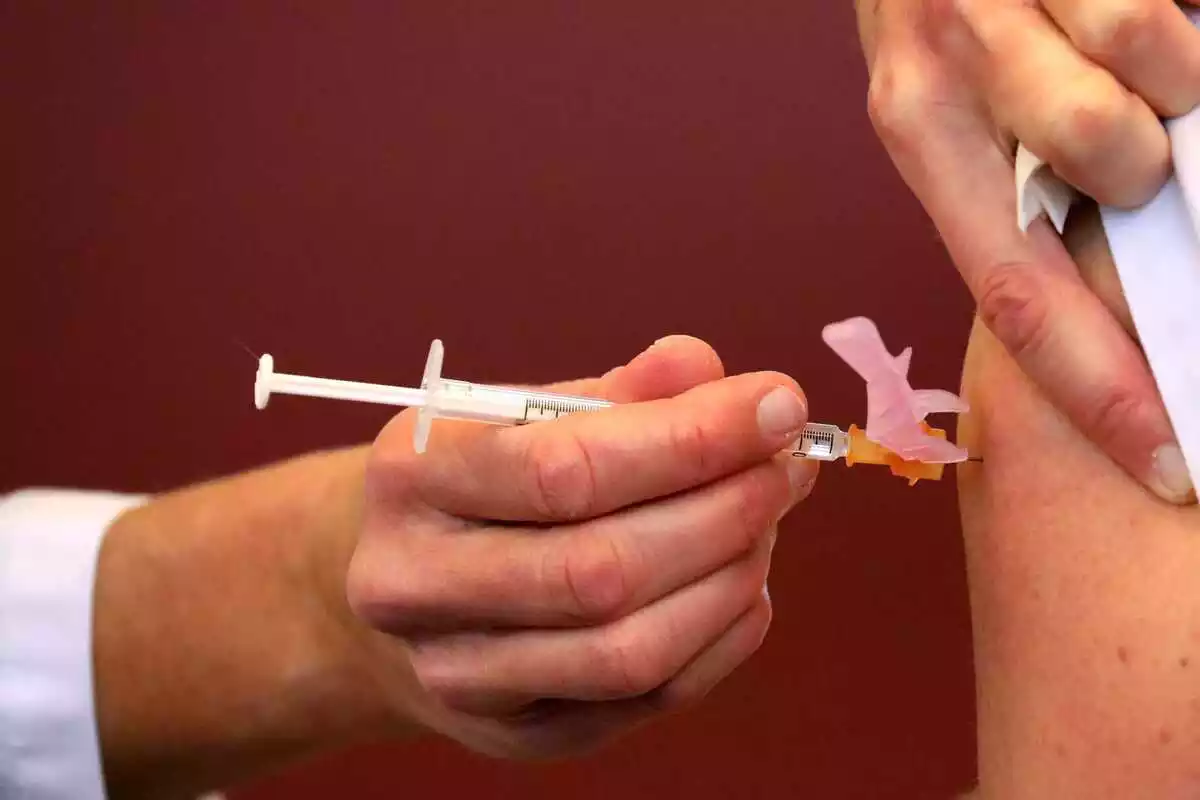 Sanitario vacunando en el brazo a una persona